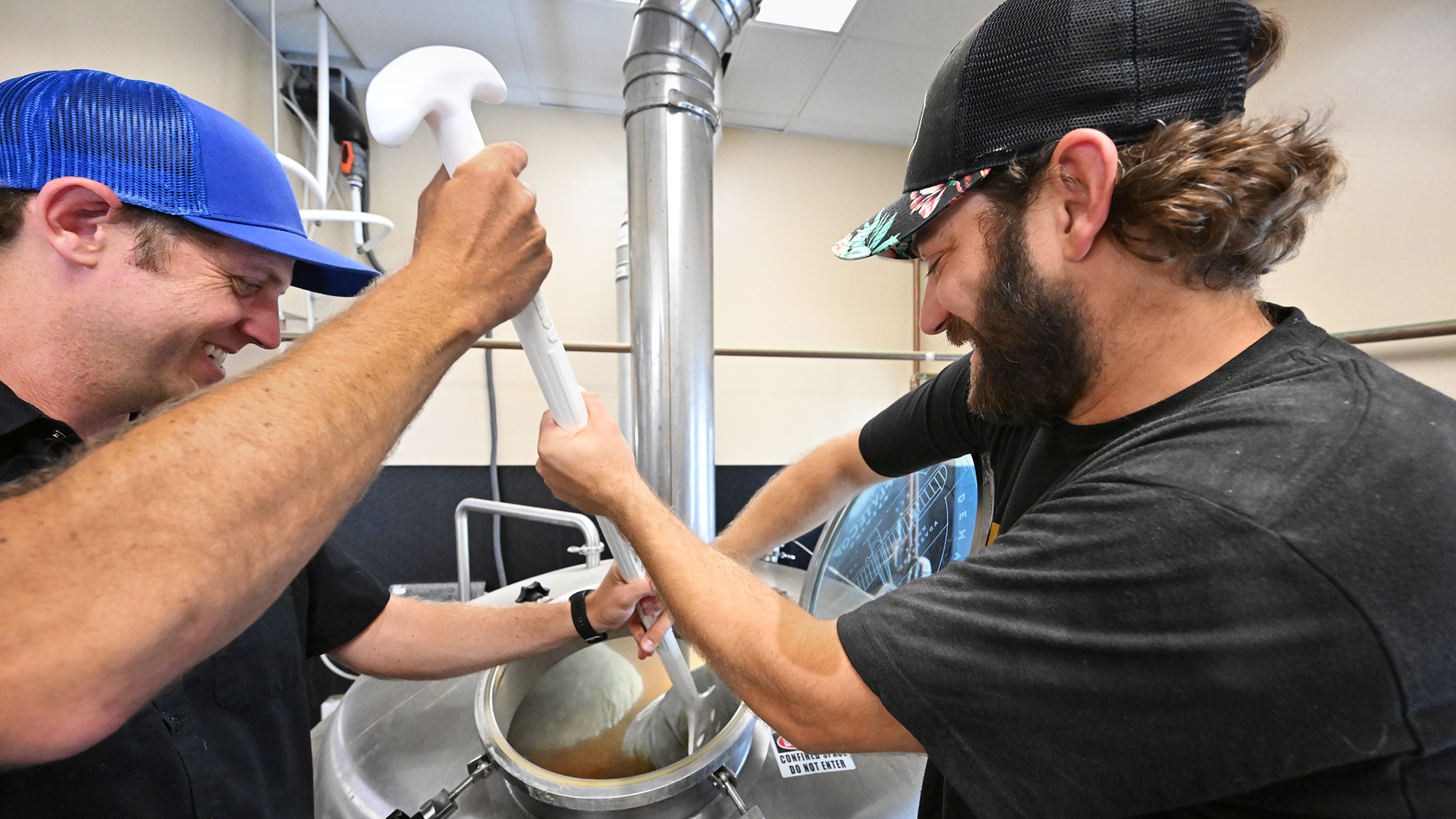 Volunteers and pilots learning how to brew