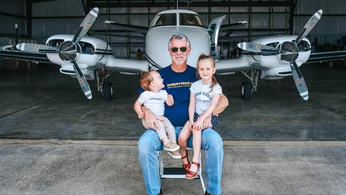 Greg Smith with his grandchildren and his Beechcraft Duke. Photo courtesy of Greg Smith.