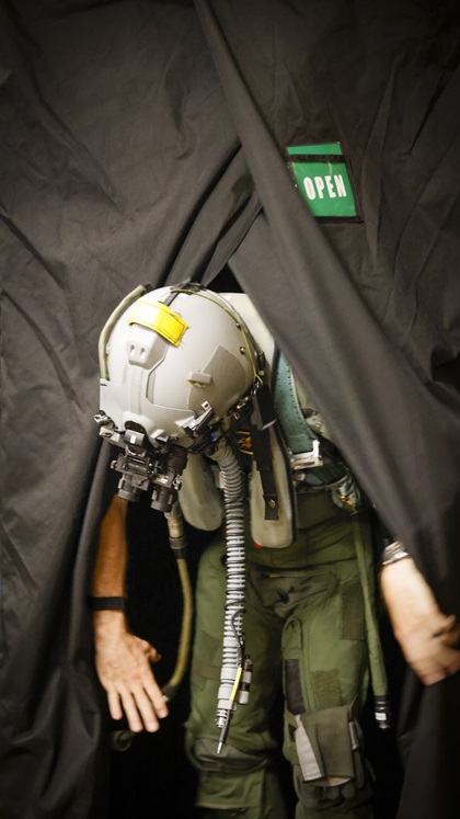 Night vision goggles are powered up and tested in a darkened enclosure prior to flight.