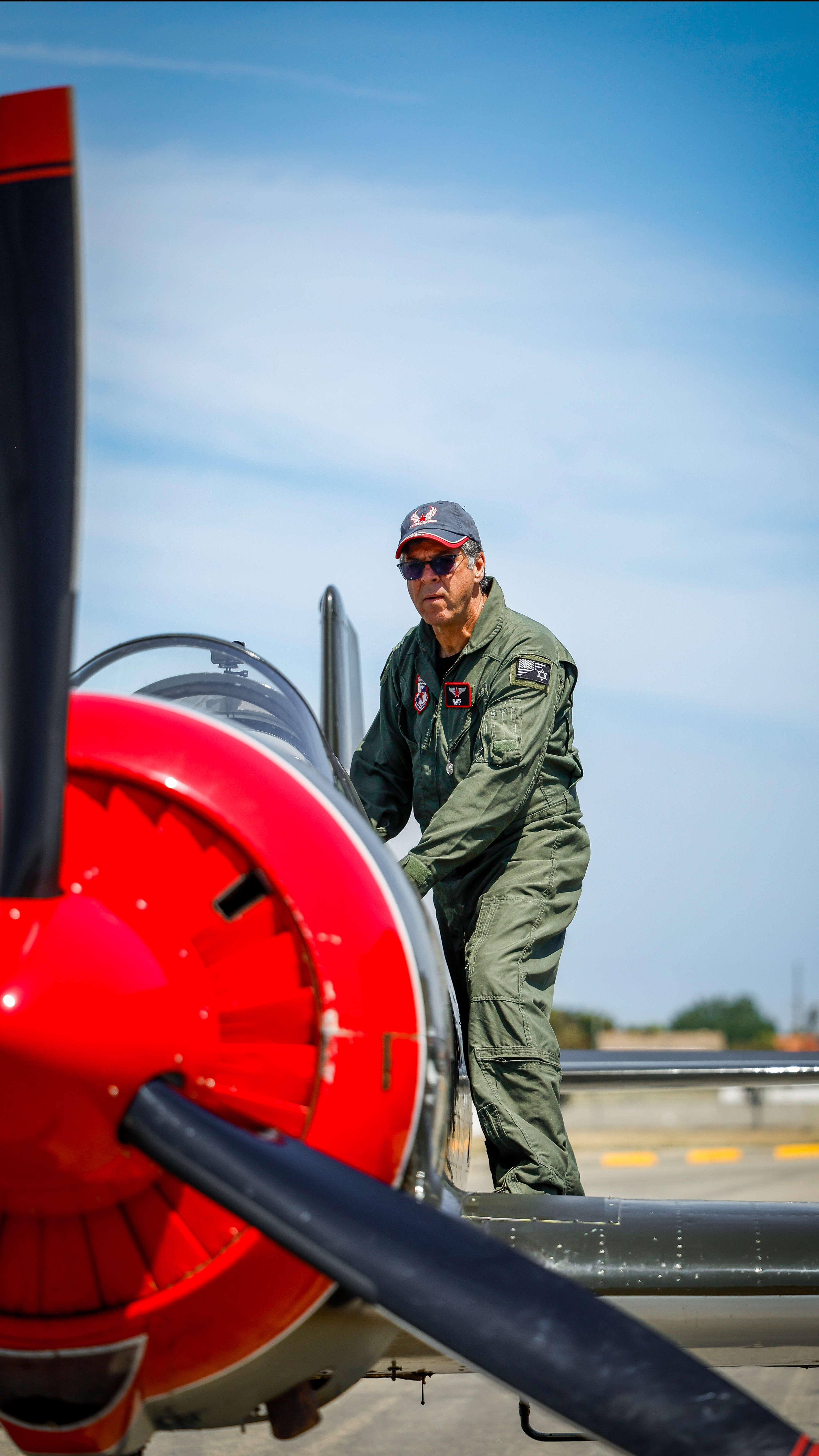 Pilot Gil Lipaz stands on the wing of his Nanchang CJ–6.