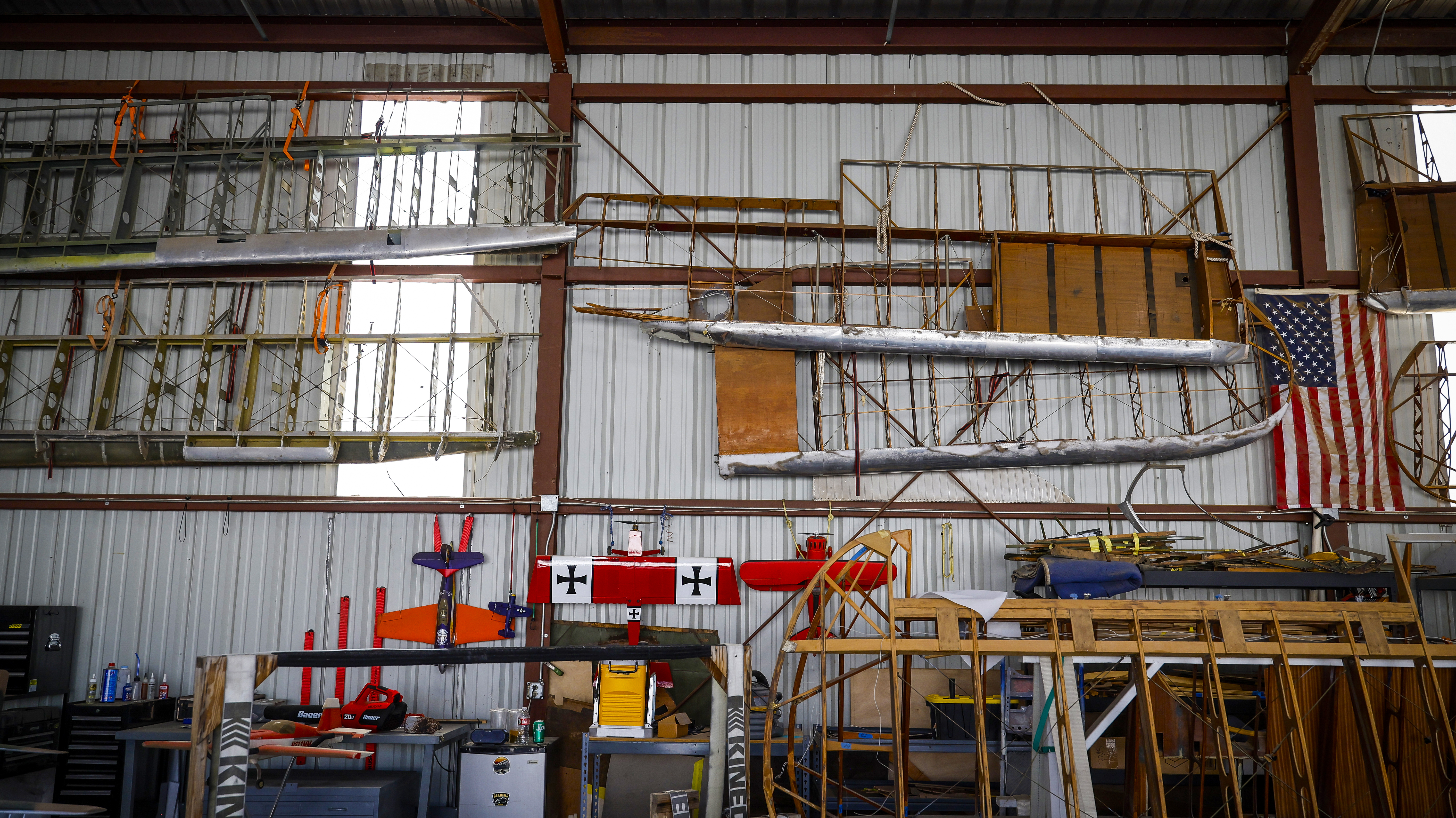 The wall of wings in a back hangar where most of the fabric work is completed.