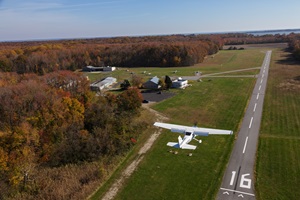 Photography of a Cessna 182 Skylane doing pattern work at Essex Skypark with fall colors.Essex Skypark Airport (W48)Baltimore MD USA