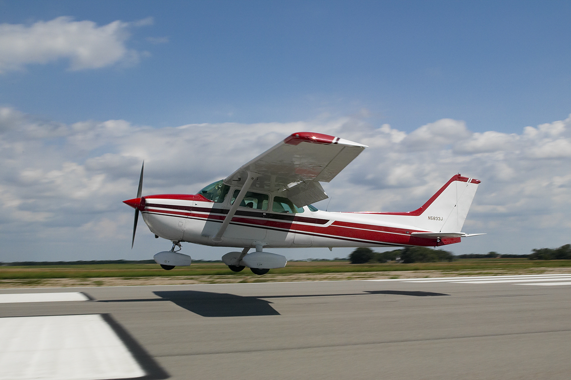 Precision Landing Cessna 172 landing at Newton, KS.
Reproduction of this image prohibited without written permission on photographer's invoice stating rights granted, and payment in full of said invoice.