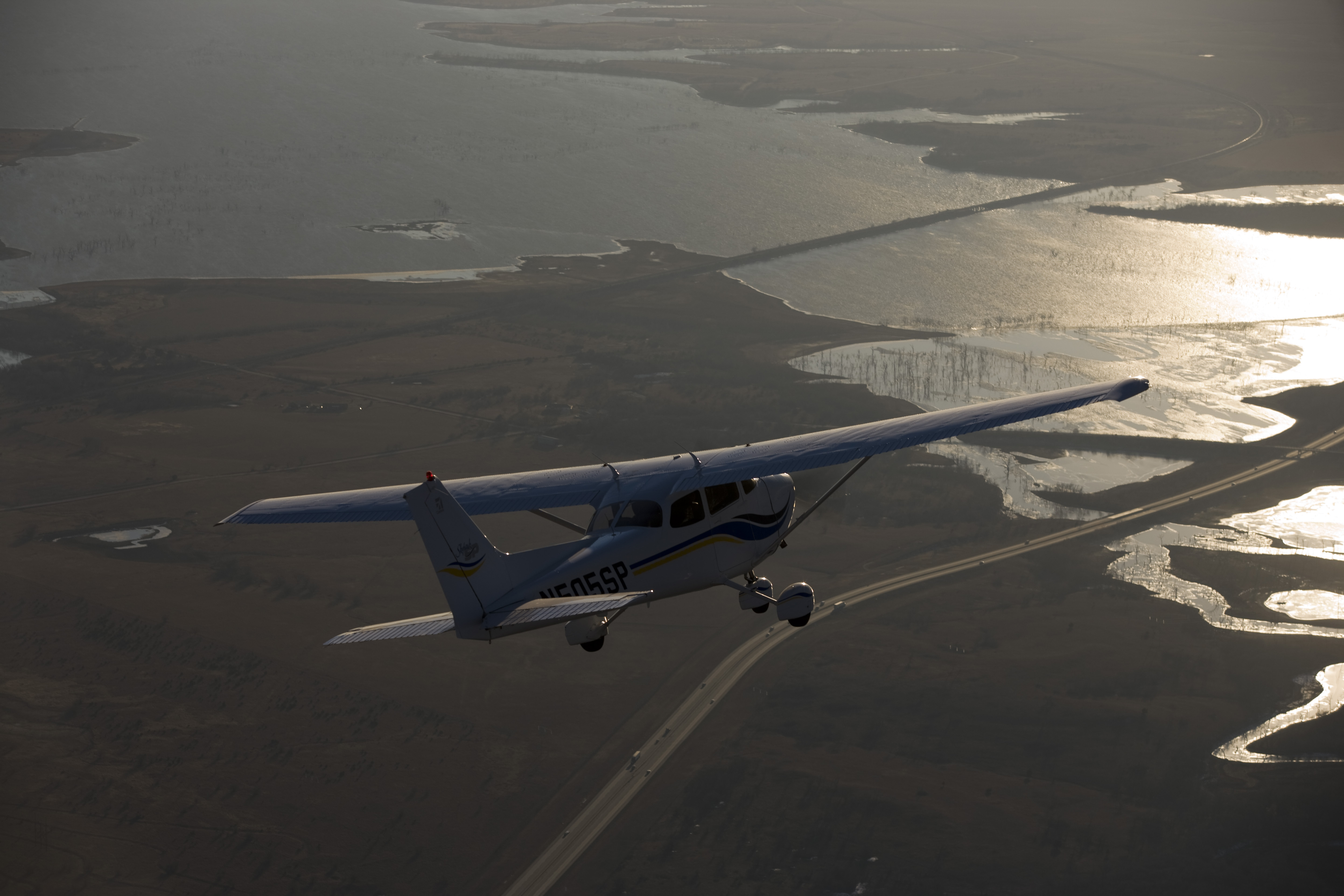 Aerial photography of a Cessna 172 flying over the Flint Hills and El Dorado Lake and I-35 on a hazy afternoon.
El Dorado, KS   USA
Image#: 06-541_362.dng   Camera: Canon EOS-1Ds Mark II 
