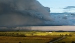 Thunder cell looms high above a rural Nova Scotia farm.  Light grain. 