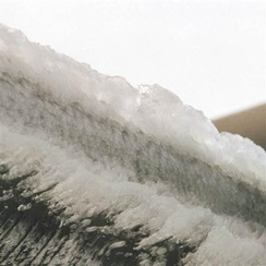 large amount of snow and ice caked onto a plane wing