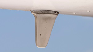 Mounted on the aircraf's belly, this transponder antenna also can transmit ADS-B Out signals. Photo by Chris Rose.