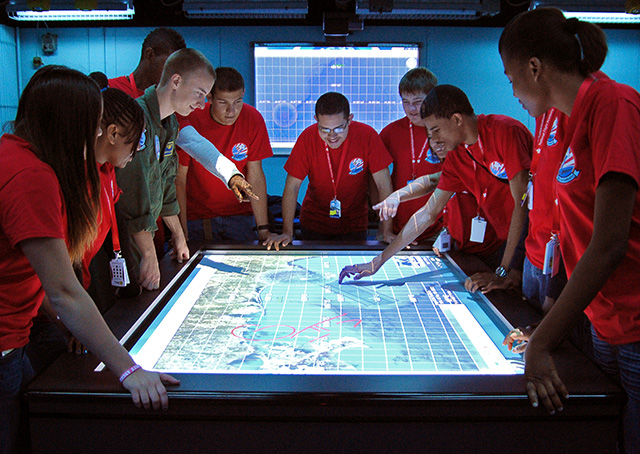 The National Flight Academy’s aviation-themed learning environment at Florida’s Naval Air Station Pensacola allows students in grades 7 through 12 to live in staterooms, eat in mess halls, and practice aviation maneuvers on flight simulators while learning science, technology, engineering, and math concepts. Photo courtesy of the National Flight Academy.