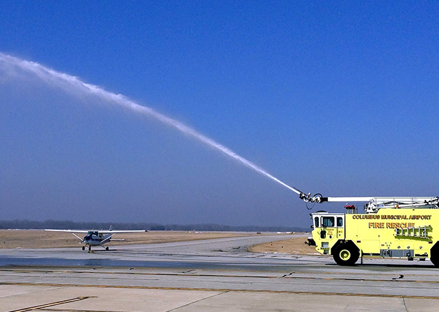 Ivy Tech Community College student Nathan Pollen is welcomed by the Columbus Municipal Airport ARFF truck  after he was the first student in the school's certificate program to solo. Photo courtesy of the Columbus Municpal Airport.