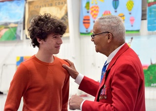 Col. Charles McGee talks with a young audience member. Photo by Mike Collins.