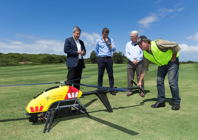 From left, Westpac CEO Brian Hartzer, New South Wales Premier Mike Baird, and Tony Haven, president of Surf Life Saving NSW, examine the Little Ripper, a version of the Pulse Aerospace Vapor 55 customized for shark spotting and water rescue in Australia. Photo courtesy of Westpac.