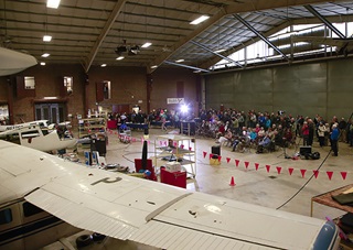 Eric Peterson thinks the hangar ceremony is just for the grass runway expansion, but AOPA has another surprise for him! Photo by Chris Rose.