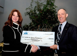 AOPA Insurance Agency President Janet Bressler presents a check to AOPA Air Safety Foundation President Bruce Landsberg to help fund avation safety quizzes.