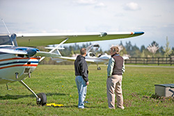 Two pilots look at their landing field.