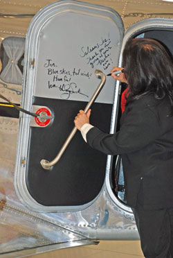 Mira Nair, director of Amelia, autographs the cabin door of Joe Shepherd’s Electra Junior.