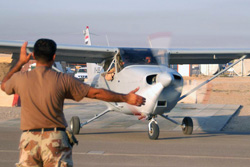 Iraqi aircraft maintainer marshals a training flight