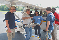 Jim Cawthon spoke to Birmingham Southern College students at his Cessna at Shelby County Airport.