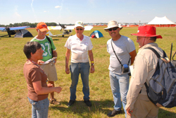 Trost, left, talks with a group of pilots at the fly-in.