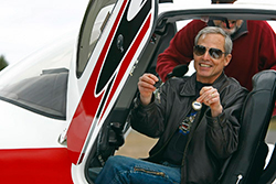 Michael Graves sits in the Cirrus SR22 and holds out the keys.