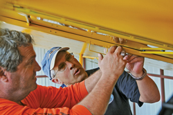 Don Glasser (left) and Mike Merritt collaborate on a Piper Cub.