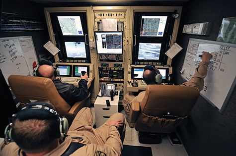 ACBP pilot and sensor operator fly a Predator from the ground control station.