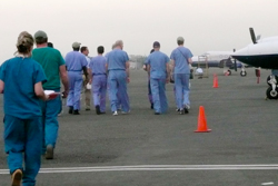 A new shipment arrives - an army of volunteers run to unload.