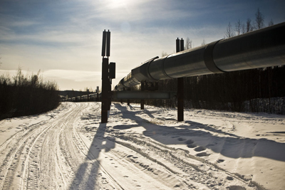 The famous Alaskan pipe line carries oil right past the Fairbanks city limits. The road built next to it has become an important link for native villages, although some have to make a two-hour run on a snowmobile to reach it.
