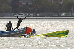Rescue divers rush to the aid of Adilson Kindlemann of Brazil after he crashes into the Swan River during the Red Bull Air Race Training day on April 15, 2010 in Perth, Australia. Photo: Cameron Spencer / Getty Images for Red Bull Air Race