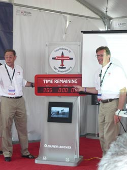 Daher CEO Patrick Daher (left) and Nicolas Chabbert, president of Socata Aircraft of North America (right), start the countdown clock for 100th anniversary celebration next year at EAA AirVenture.