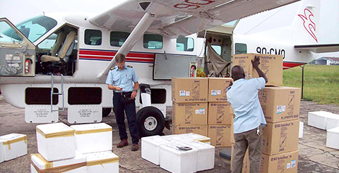 MAF personnel load vaccines aboard a waiting plane at the Kinshasa airport. MAF is providing flights to combat a measles outbreak in the Democratic Republic of the Congo. Photo by Garth Pederson.