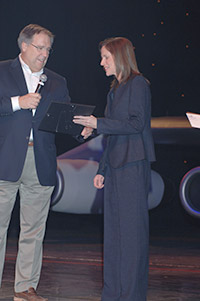 Krista Crandall (right) receives a scholarship from AOPA President Craig Fuller
