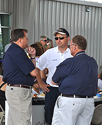 John Gallo, center, speaks with volunteers at Indiana Executive Airport's Fifth Annual Fly-In and Open House.