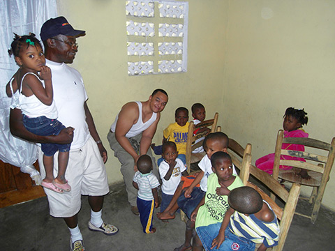 Carl L. Works introduced his son Carl I. Ross-Works to some of the children his organizations are helping in Haiti.