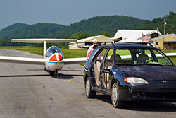 A doorless Hyundai serves as a glider tug and people mover.