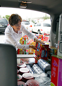 Catherine Ahles of Premier Aircraft Sales donated an SUV full of food to fill an aircraft.