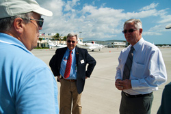 AOPA President Craig Fuller (left) speaks with Ted Soliday, executive director of the Naples Airport Authority (center), and Bob Knight, chairman of Sun 'n Fun (right).