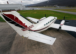 The wide cabin and plentiful windows provide a comfortable capsule for passengers on long flights. The bird-like paint scheme continues across the airplane from nose-gear fenders to engine cowling.