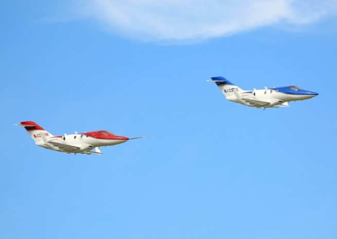 Two conforming HondaJets in formation at EAA AirVenture 2013