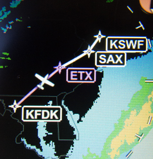An XM weather datalink radar view on an Aspen MFD shows that precip has moved off the Mid-Atlantic coast, along with flight plan waypoints.