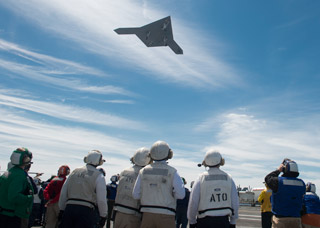 UA makes pass over aircraft carrier after launch.