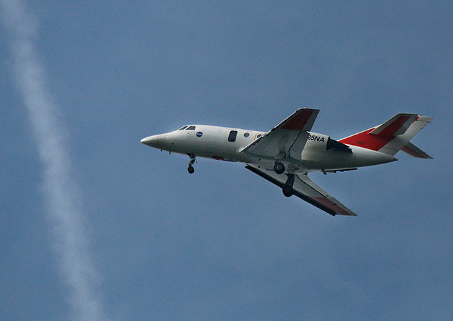 A NASA Langley Research Center HU-25C flew relatively close to the ground near its home in Hampton, Va., on a mission to collect as many bug strikes as possible. Credit: NASA Langley/David C. Bowman