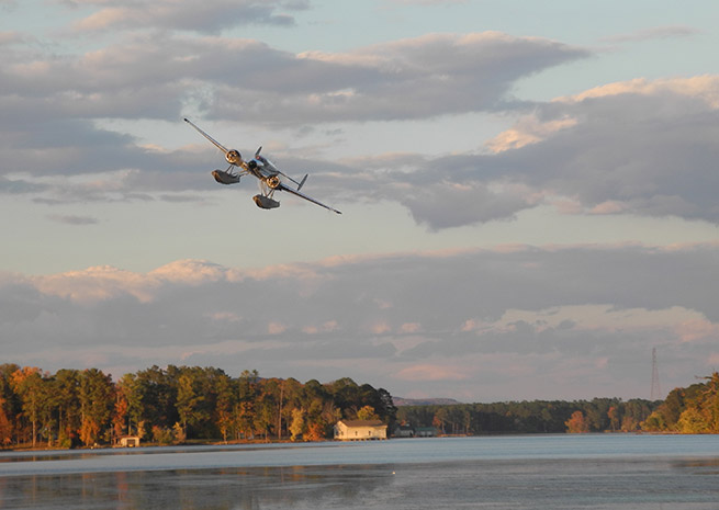 AOPA President Mark Baker brings his Beech 18 in for a low pass over the field at Guntersville, Alabama.