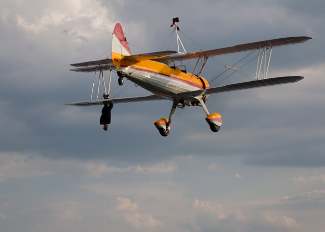 The deaths of wing walker Jane Wicker, shown here in a 2011 performance, and pilot Charlie Schwenker shocked the airshow industry.