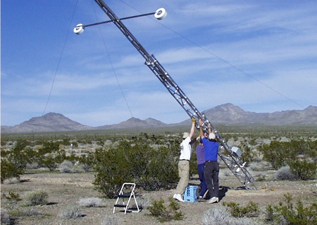 National Oceanographic and Atmospheric Administration personnel raise a 10-meter meteorological tower. NOAA photo.