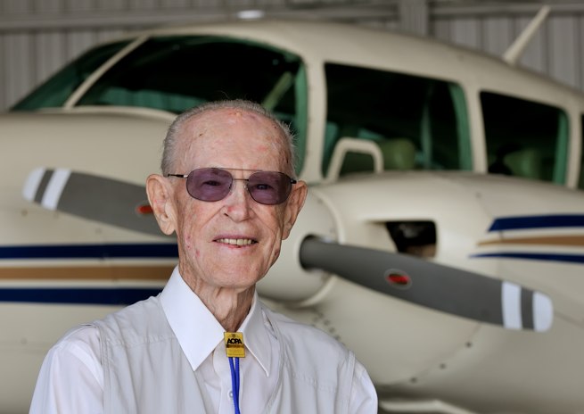 Bill Bailey poses with Mark Miller's Piper Aztec at Base Ops, on Page Field in Fort Myers, Fla.