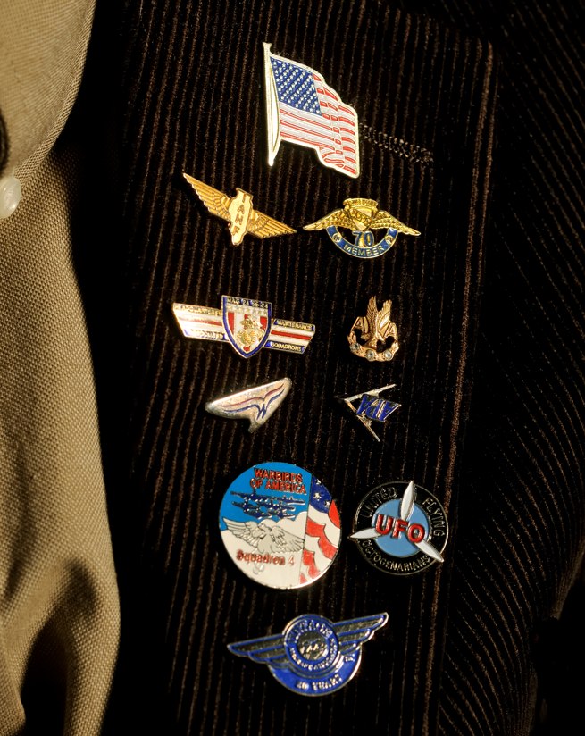 Hess proudly wears a collection of aviation lapel pins.