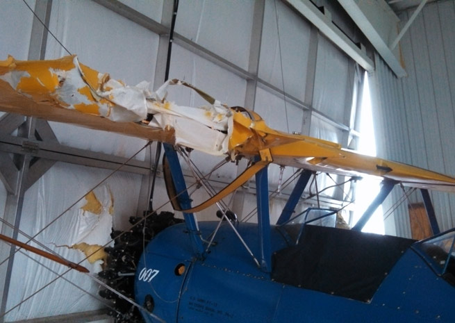 A Stearman was damaged when the wind blew in the hangar doors at Lakeview Airport. Photo courtesy of Michael Matthews.