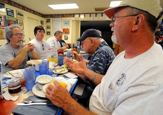 Pilots talk during their weekly breakfast visit to Flo's Airport Cafe.