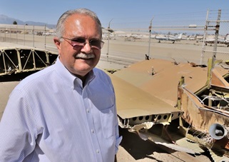 Bob Hayden with wreckage of the Bushmaster 2000 his father built.