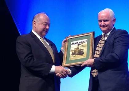 AOPA President Mark Baker presents a framed copy of "AOPA Pilot" magazine to then-HAI President Matt Zuccaro during HAI Heli-Expo 2014. Zuccaro flew Bell Huey helicopters in Vietnam.